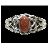 Sterling silver prong set goldstone ring in