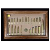 NRA U.S. Military Cartridge Board in wooden frame,