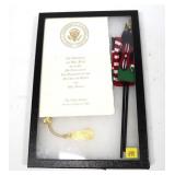 George Bush welcoming program with flag, 2003