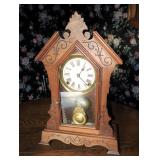Carved walnut shelf clock, 13" W x 19" H.