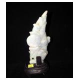 7.5" carved stone with wooden base