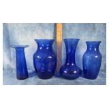 FOUR BLUE GLASS VASES