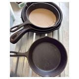 Group of cast iron skillets as shown