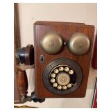 Reproduction of an old wall phone with vintage-style crank telephone design. Decorative piece with antique telephone appearance, suitable for wall display, country store décor, office, bar, or rustic