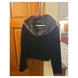 Black Rivet faux fur coat with dark plush exterior. Modern fashion coat suitable for winter wear, costume use, display, or resale.
