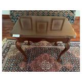 Wooden side table with pull-out side extensions and traditional styling. Compact accent table suitable for use beside a chair, sofa, or bed. Measures approximately 27 in. tall x 28 in. wide x 19 in. d