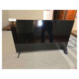 TCL Roku 32-inch television. Flat-screen TV with Roku smart TV features. Includes stand/base as shown.