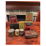 Ten vintage tins as shown. Includes assorted advertising and storage tins with printed graphics and age-related wear. Decorative collectible group suitable for display.