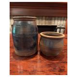 Two pieces of stoneware pottery as shown. Includes one handled stoneware piece measuring approximately 7 in. tall x 5 in. wide and one smaller stoneware piece measuring approximately 4 in. tall x 5 in
