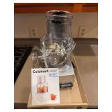 Cuisinart food processor with work bowl, lid, and blade/accessories as shown. Appears barely used. Countertop kitchen appliance suitable for chopping, slicing, shredding, and general food prep.