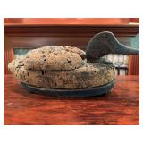 Cork duck decoy with painted finish and carved wood head. Traditional hunting or decorative decoy with age-related wear and use.