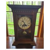 Ethan Allen mantle clock with traditional wood case and classic face design. Decorative tabletop clock suitable for mantel, shelf, desk, or cabinet display.