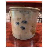 Norton & Fenton 2-gallon stoneware crock with blue floral decoration and side handles. Antique stoneware piece with maker’s mark on front.