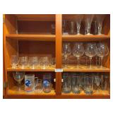 Glassware from kitchen as shown. Assorted drinking glasses and related kitchen glassware suitable for dining, entertaining, replacement pieces, resale, or general household use.