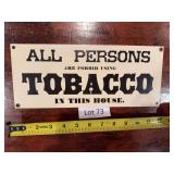 Metal tobacco advertising sign with printed graphics and aged display surface. Tobacco-related advertising collectible suitable for display in a collection, shop, bar, office, or man cave.