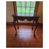 Wooden side table with pull-out side extensions and traditional styling. Compact accent table suitable for use beside a chair, sofa, or bed. Measures approximately 27 in. tall x 28 in. wide x 19 in. d