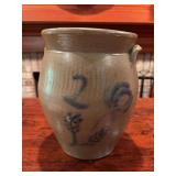 2-gallon handmade stoneware crock with blue floral decoration. Measures approximately 11 in. tall x 9 in. wide. Appears to be in good condition.