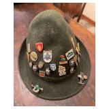 Vintage Swiss Alpine / Tyrolean-style felt hat with assorted souvenir and decorative pins. Traditional Alpine folk-style hat with travel and regional display appeal, suitable for Swiss, Tyrolean, Okto