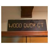 Custom painted wood sign reading “Wood Duct Ct.” Features framed construction with decorative lettering and rustic display style.