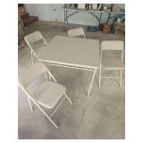 Card table with four folding chairs. Portable table and chair set suitable for games, crafts, extra seating, events, garage use, or general household use.