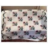 Vintage quilt with patterned fabric design. Appears to be machine stitched. Measures approximately 79 in. x 81 in.