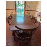 Wood dining room table with six matching wooden chairs. Table measures approximately 30 in. tall x 40 in. wide x 72 in. long. Traditional dining set with shaped chair backs and wood seats.