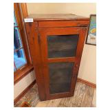 Antique pie safe or storage cabinet with screened panel doors and interior shelving. Constructed of painted wood with rustic country styling and ventilated wire screening designed for food or pantry s