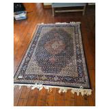 Area rug with traditional patterned design and neutral tones. Decorative floor covering suitable for living room, bedroom, dining area, or entry space.