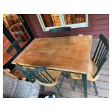 Wood table with four matching chairs. Table shows wear and will need refinished. Dining or kitchen set suitable for use as a refinishing, restoration, or project piece.