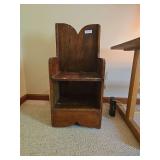 Antique children’s lambing chair with wood frame and enclosed side design. Features a low seat, high back, and traditional primitive construction. Child-sized chair with rustic country character.