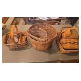 Eight Longaberger baskets as shown. Assorted basket group with woven wood construction and traditional Longaberger styling, suitable for collecting, display, storage, gift baskets, or resale.