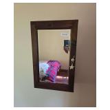 Antique medicine cabinet with mirrored door and wood frame. Compact wall cabinet suitable for bathroom storage, display, or primitive décor use. Located on second floor; buyer should bring help and t
