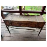 Long decorative box on stand with painted finish and ornamental design. Shows a fair amount of wear, surface loss, and age-related distressing. Decorative piece suitable for rustic, primitive, porch, 