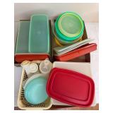 Three flats of assorted Tupperware storage containers, bowls, lids and kitchen pieces in a variety of colors, shapes and sizes as shown.