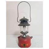 Sears Roebuck Model 476.74550 pressure lantern with red fount, black ventilator, clear globe and Sears Roebuck and Co. decal; marked 12/63. Shows surface wear, dust and age-related use.