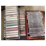 Group of assorted cassette tapes and compact discs in storage cases and boxes, including music, Christmas, gospel, classical and other recordings as shown.