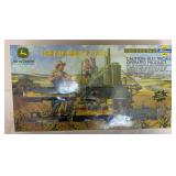 Athearn John Deere Model B Express HO scale train set with John Deere-themed locomotive and rolling stock. Includes two die-cast Model B tractors and remains in the original box.