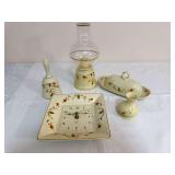 Five-piece Autumn Leaf group including a square Hall clock, covered butter dish, bell, small vase and glass-chimney lamp. Clock is marked “1994 China Specialties Exclusive Limited Edition by Hall”