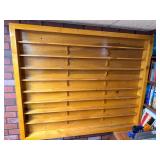 Handmade wood wall-mounted display shelf with multiple long narrow shelves designed for displaying model trains or other collectibles. Natural stained finish with decorative wood shelf supports.