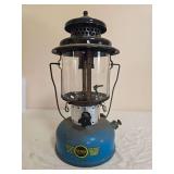 Sears Roebuck Model 476.74060 pressure lantern with blue fount, black ventilator, clear globe and Sears Roebuck and Co. decal; marked 5/65. Shows paint wear, oxidation and age-related use.