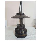 Preway Pretiss-Wabers Co. Model L46S pressure lantern with black fount and ventilator, clear globe and tall metal carrying handle. Shows paint loss, surface wear and oxidation consistent with age.