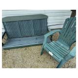 Outdoor furniture grouping including green porch swing, matching-style Adirondack chair and tables as cataloged. Shows outdoor weathering and use. Some slats need repaired or replaced