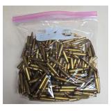 Large resealable bag containing loose .223 rifle ammunition with brass cases and copper-colored bullets as shown.