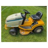 Cub Cadet 2150 riding lawn mower with mower deck and rear-mounted seat. Runs and drives; seat shows visible tape repair. Needs tires.