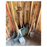 Group of long-handled lawn and garden tools including shovels, rakes, post-hole digger, cultivators and other tools as shown.