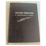 Hardcover volume titled The First World War: A Photographic History with black cloth-style cover and rifle illustration. Shows general age-related shelf wear.