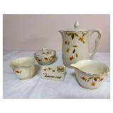 Five-piece Hall Jewel Tea Autumn Leaf grouping including a large lidded coffee pot, lidded covered dish, two creamers and a ceramic “Hall Genuine Autumn Leaf” collector plaque, all with cream glaz