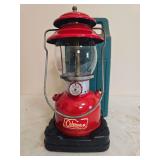 Coleman Model 200A Red Lantern with Case. Red painted fount with matching red porcelain ventilator, clear Pyrex Coleman globe, wire bail handle and carrying case; shows age-related wear and finish los