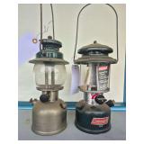 Coleman Models 242C & 288A Lanterns – Marked 5/49 & 3/99. Includes earlier 242C pressure lantern and later 288A adjustable lantern with clear globes and wire bail handles; shows varying age-related 