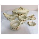 Six-piece Hall Autumn Leaf group including a covered casserole, gravy boat, two handled cups, candleholder and small dish, all with gold trim. Markings include NALCC 10th Anniversary 1988, NALCC 1999,
